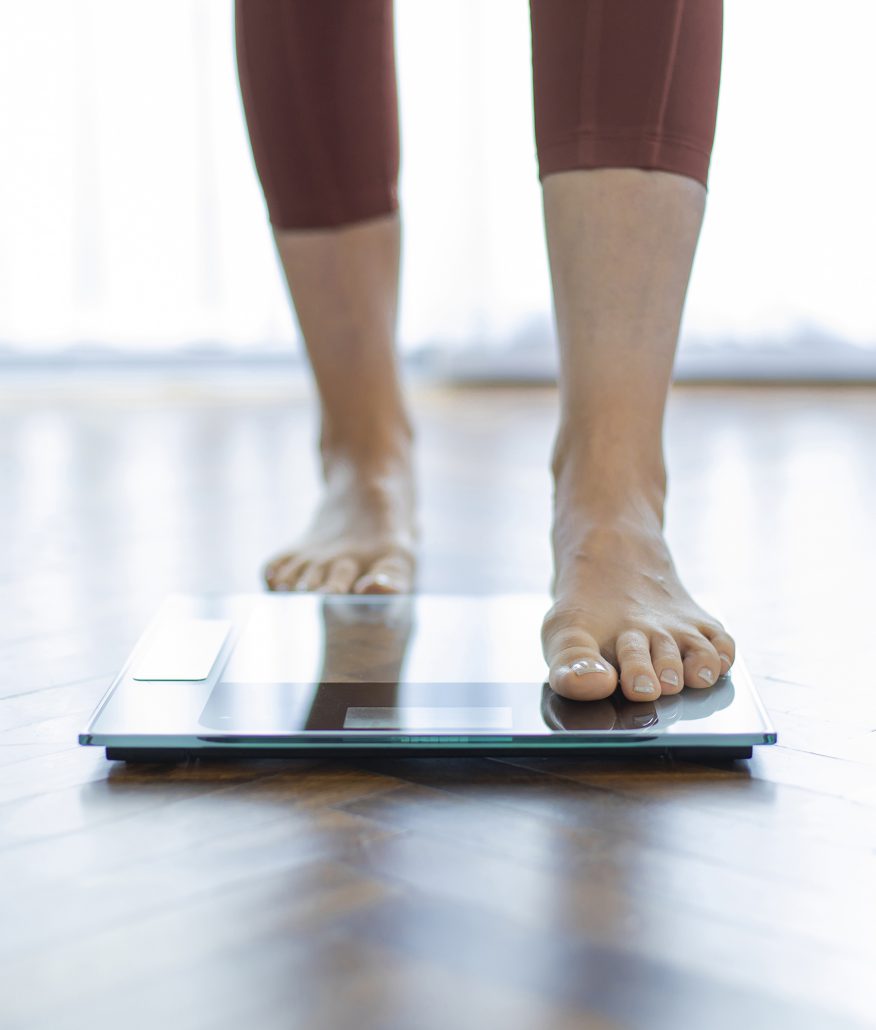 Young woman on home scales